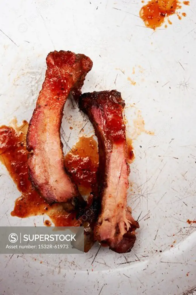 Two Barbecue Pork Ribs with Barbecue Sauce Splatters