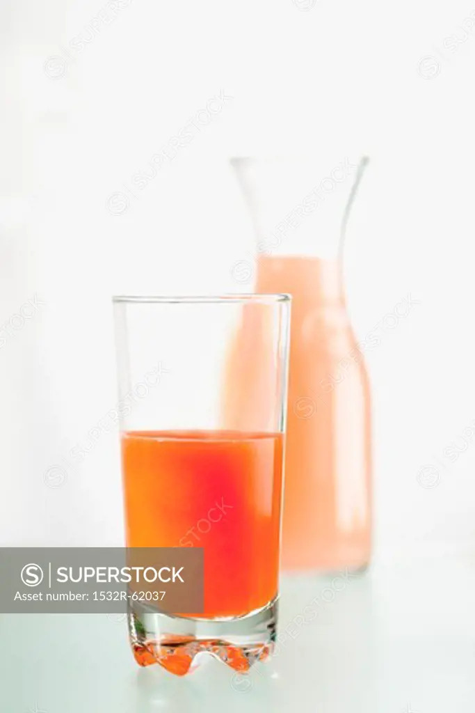 Blood orange juice in a glass and a carafe
