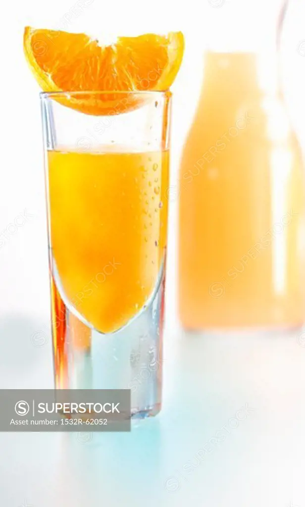 An orange juice shooter