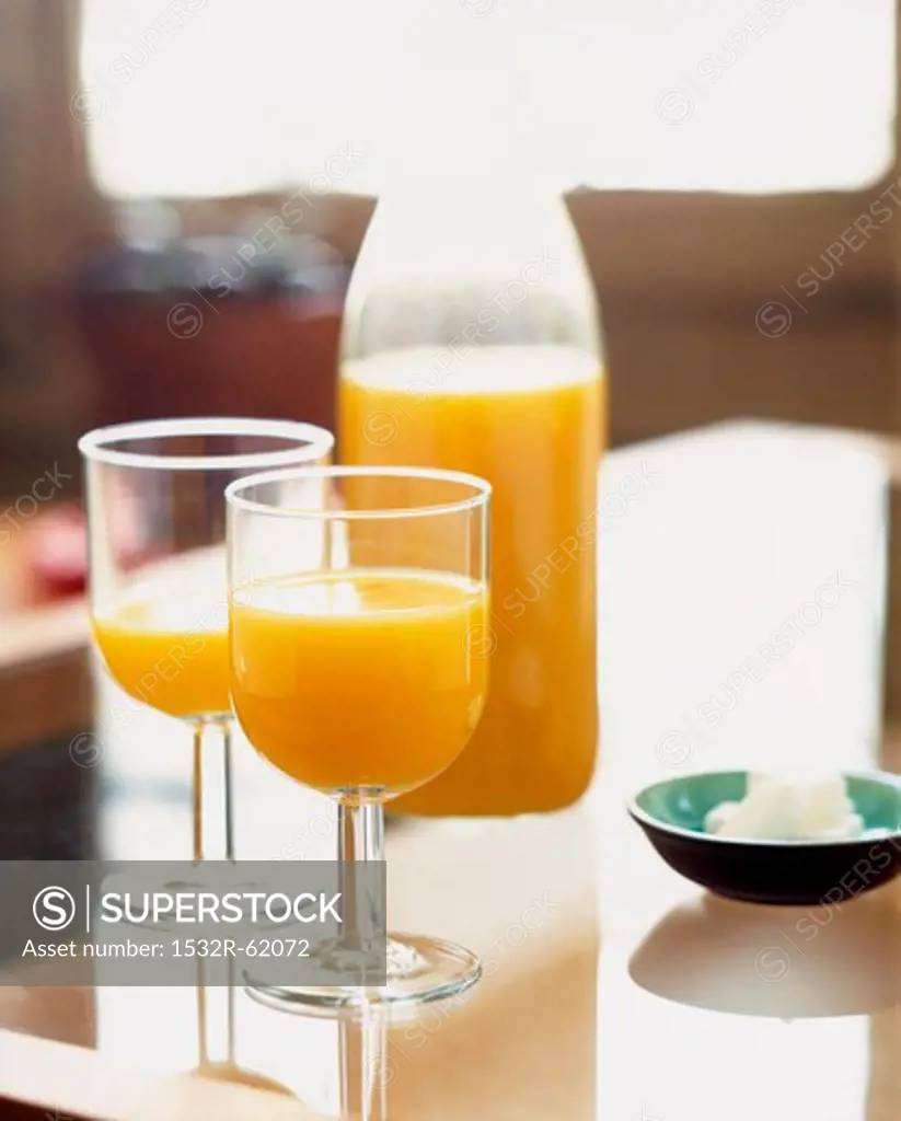 Orange juice in glasses and a bottle
