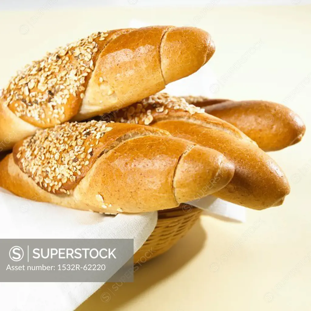 Several grain baguettes in a bread basket