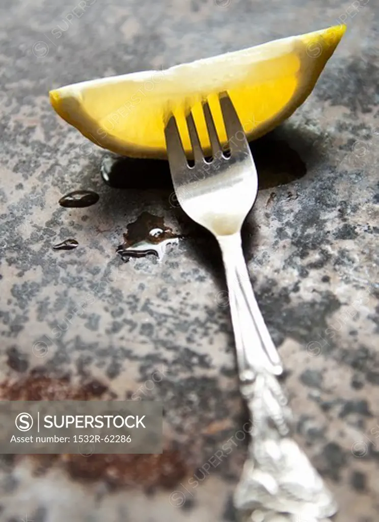 A lemon wedge on a fork