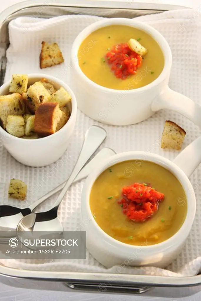 Butternut squash soup with puréed peppers and croutons