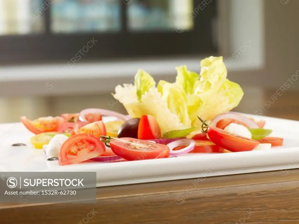 A tomato salad with three different types of tomato