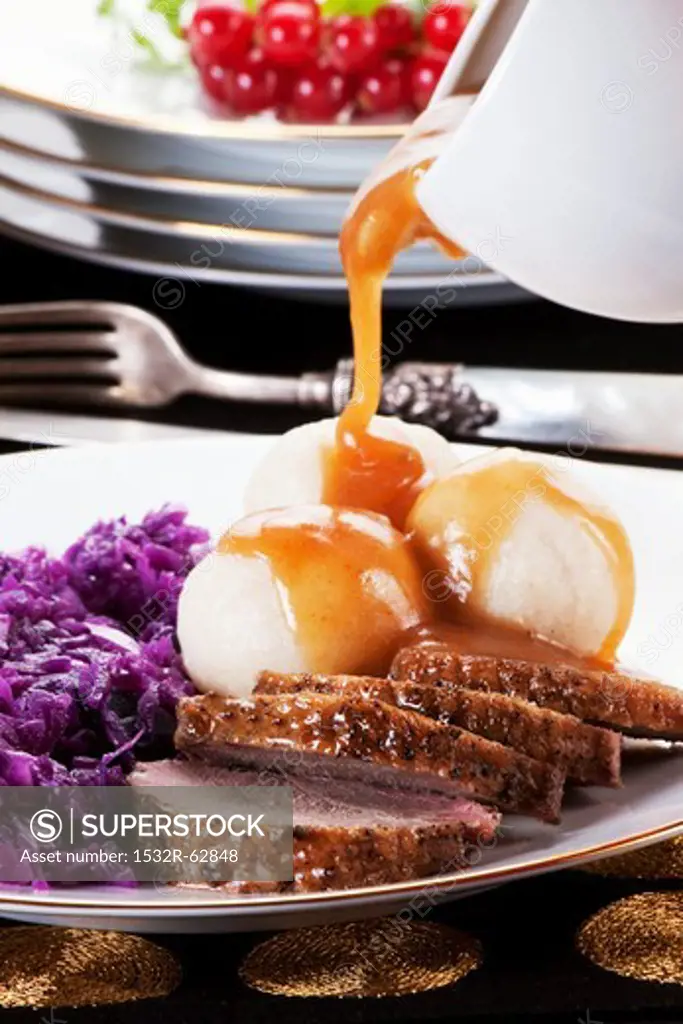 Roast goose with dumplings, red cabbage and gravy