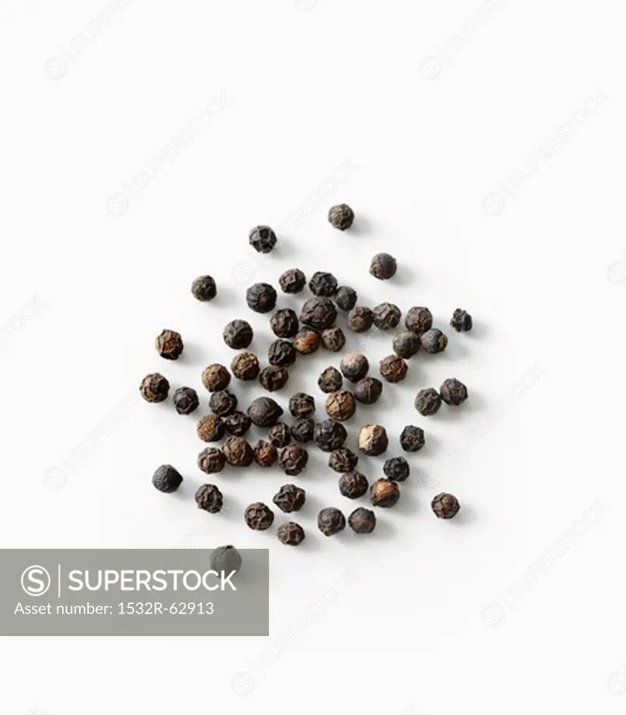 Black pepper in scoop, close-up
