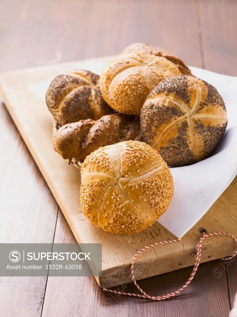 Sesame rolls, poppy seed rolls and seeded baguettes in a bread basket
