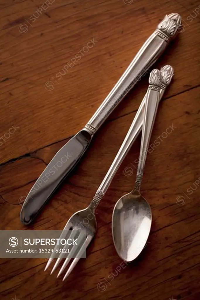 Silver Knife, Fork and Spoon on a Wooden Table