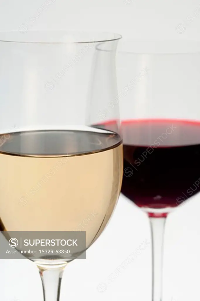 A glass of white wine and a glass of red wine
