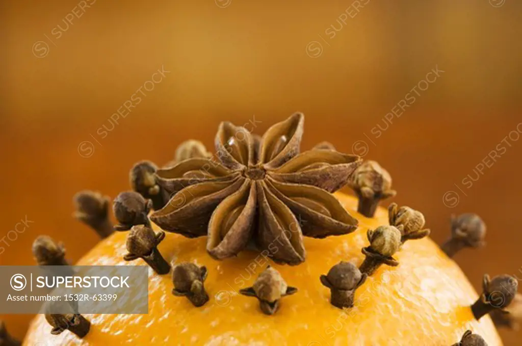 An orange pierced with cloves and an anise star