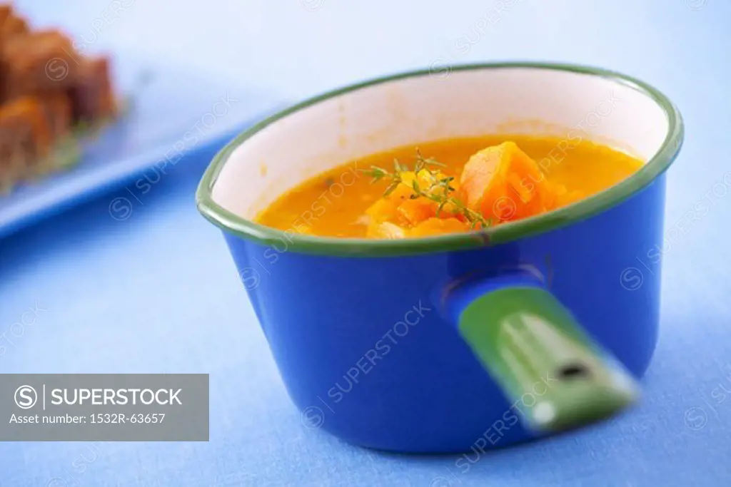 Pumpkin soup in a blue pot