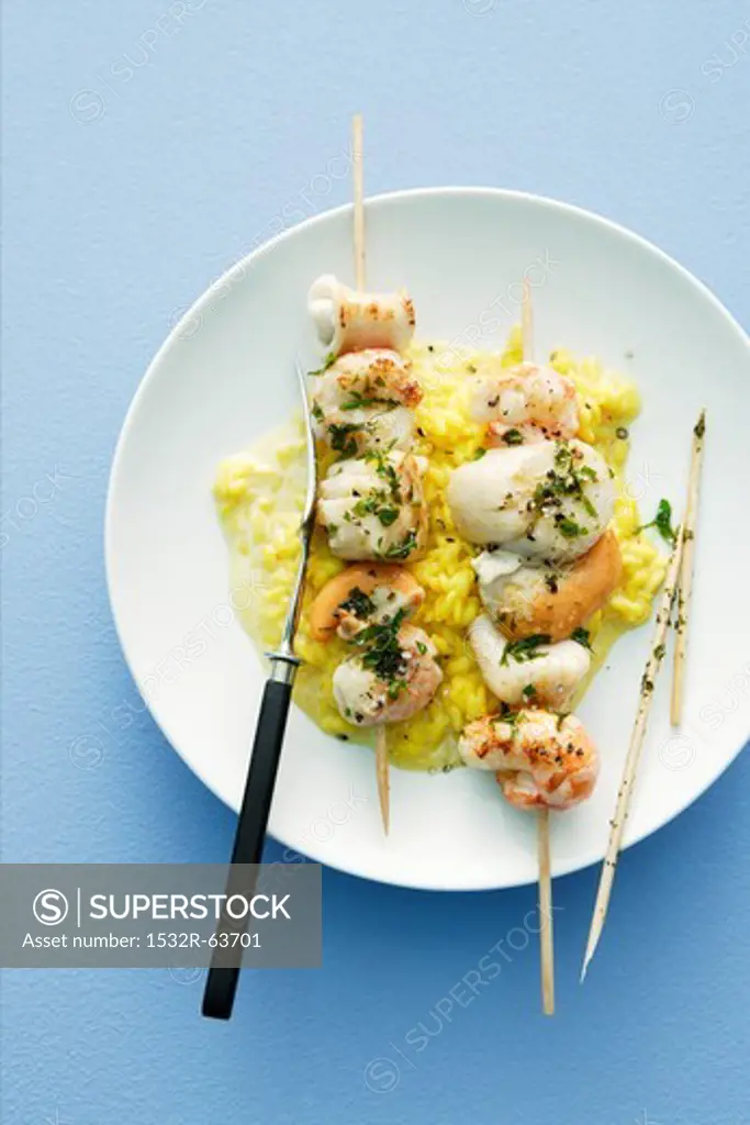 Seafood kebabs on a bed of saffron risotto