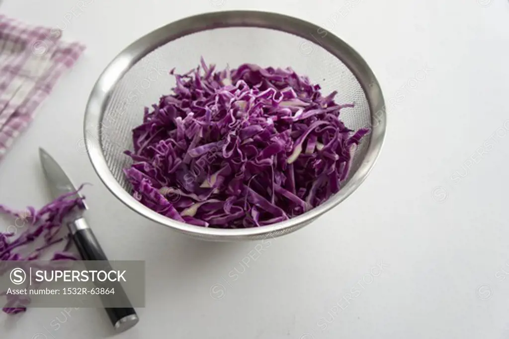 Chopped red cabbage in a sieve