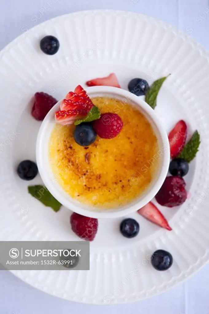 Creme Brulee in a Ramekin with Fresh Fruit and Mint; From Above