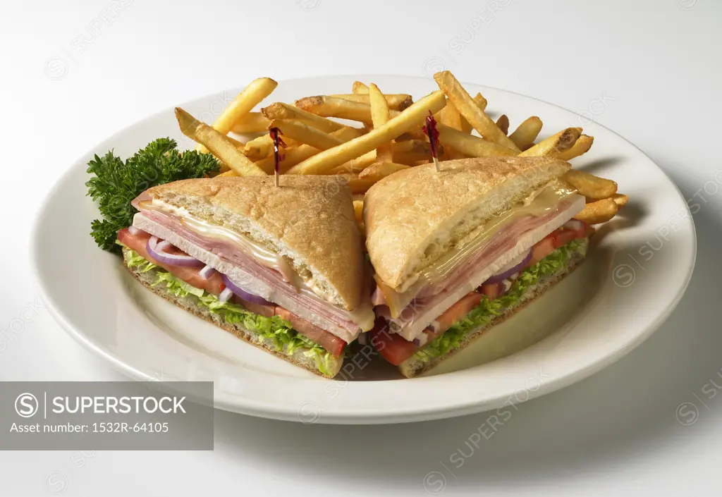 Club Sandwich on Ciabatta Bread; Halved with French Fries