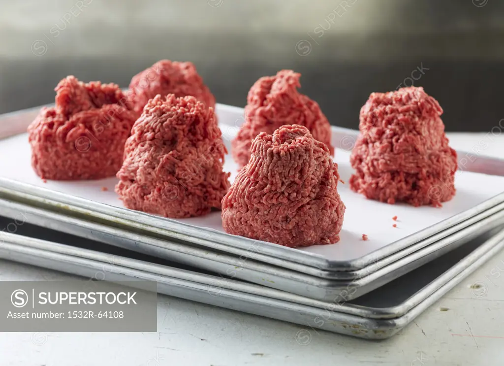 Small Piles of Raw Ground Beef on a Sheet Pan
