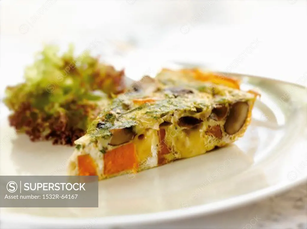 A Slice of Sweet Potato and Gouda Cheese Frittata with a Tossed Salad in a White Plate