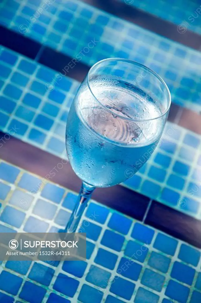 A glass of water by the pool