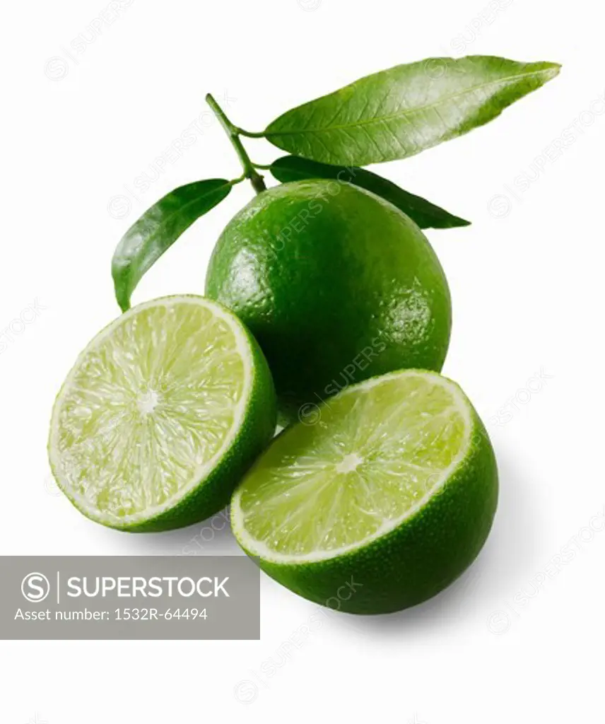 Two lime halves in front of a whole lime