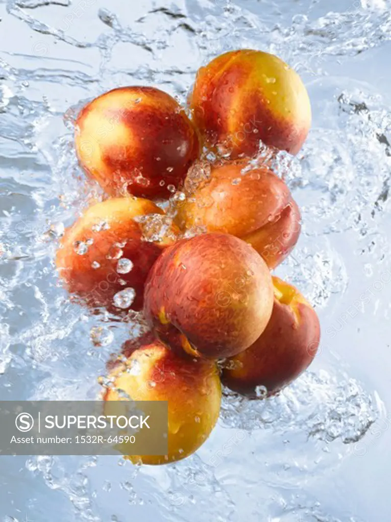Nectarines doused in running water