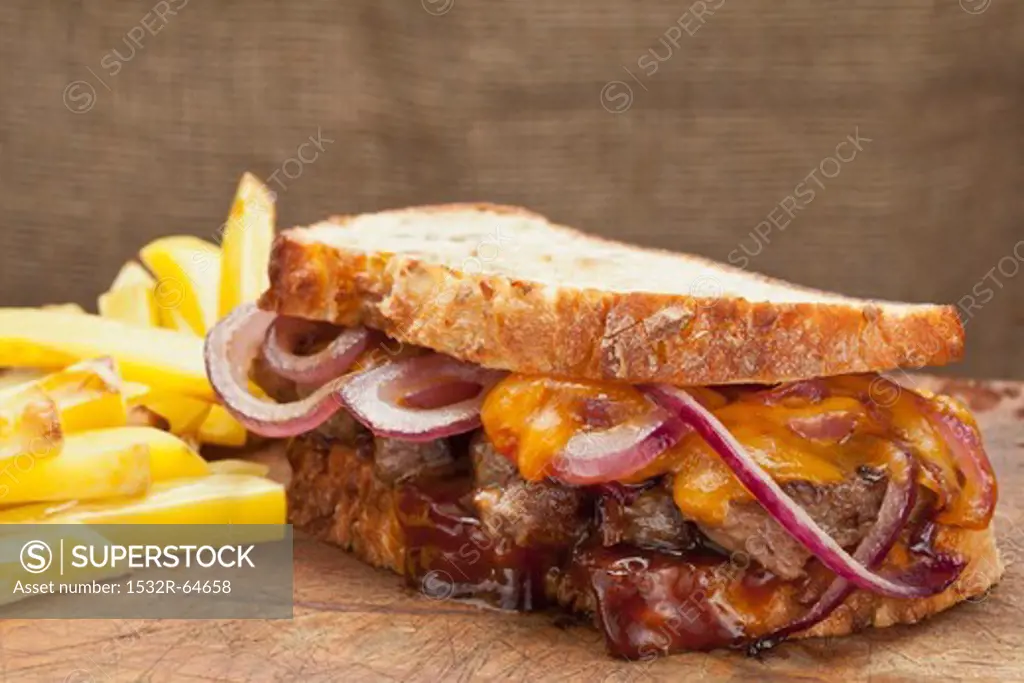 Steak sandwich with cheddar, onions and BBQ sauce