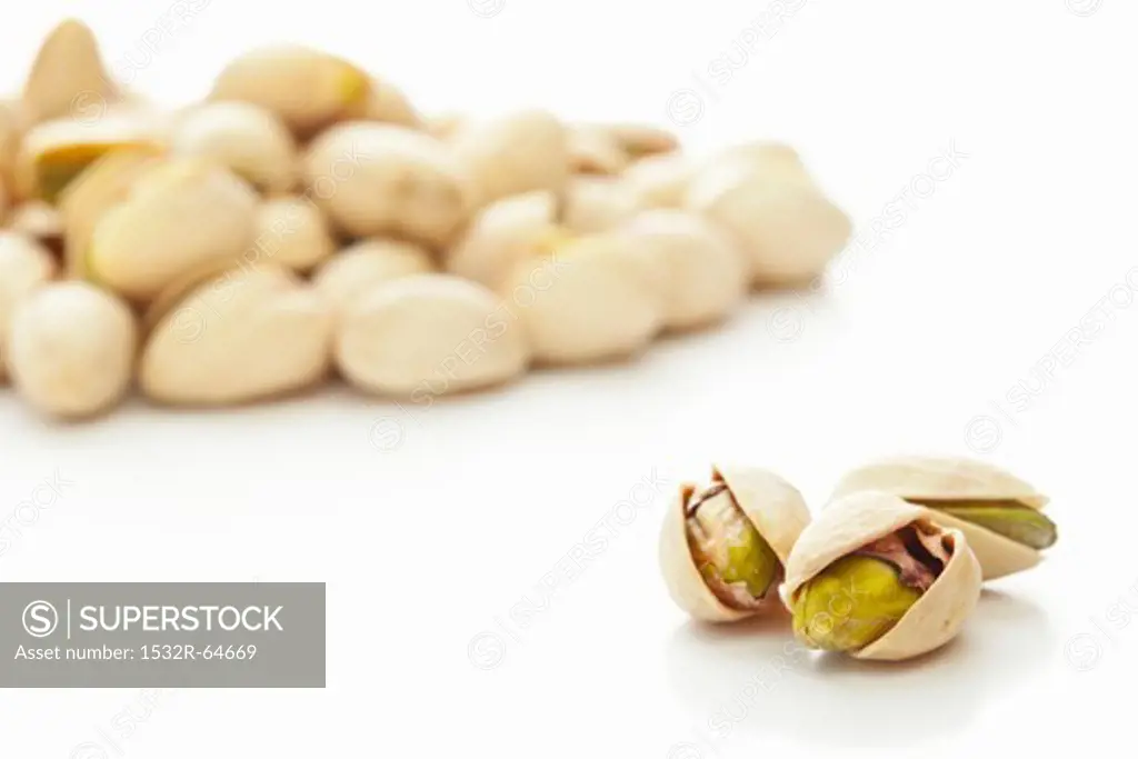 Toasted pistachios against a white background
