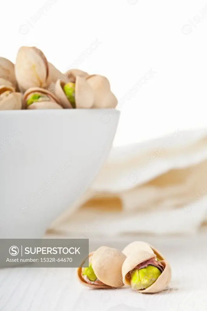 Toasted pistachios in a white bowl