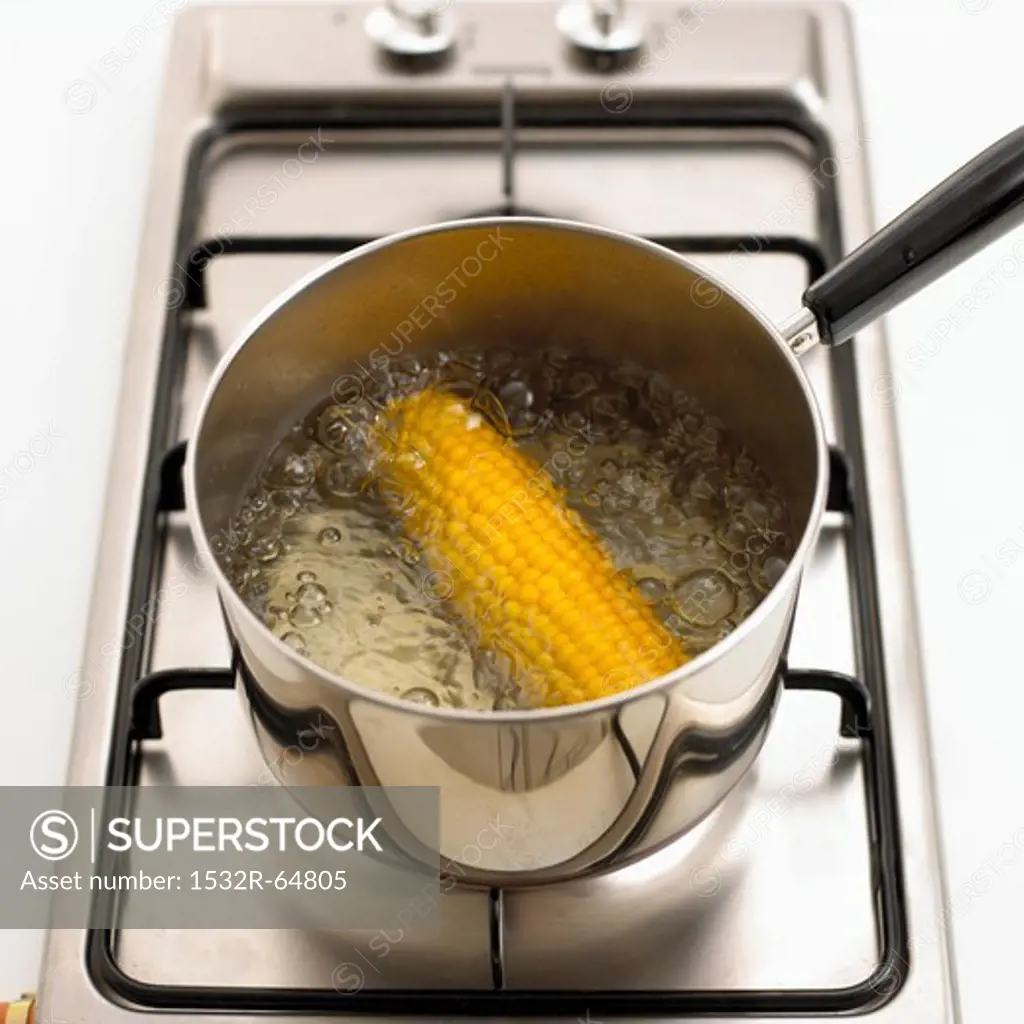 A corn cob being boiled