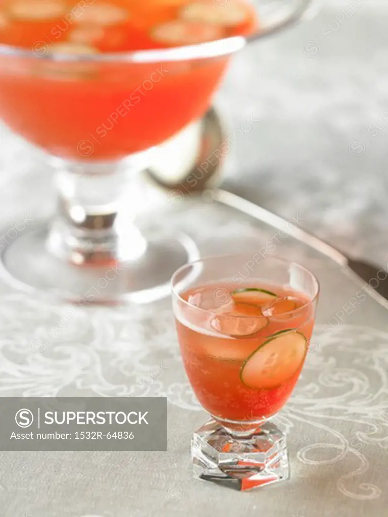 Glass of Venetian Punch Royale with Cucumber Slices; Punch Bowl