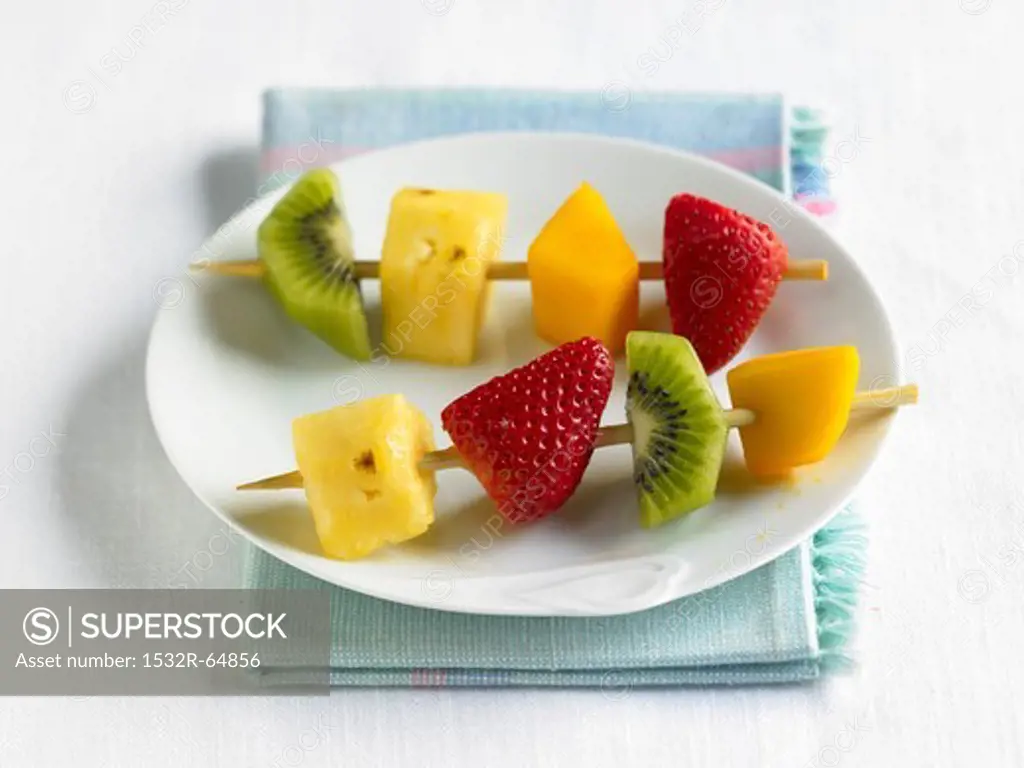 Two Fruit Kabobs on a White Plate