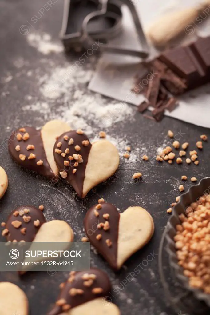 Heart-shaped biscuits with chocolate glaze and chopped nuts