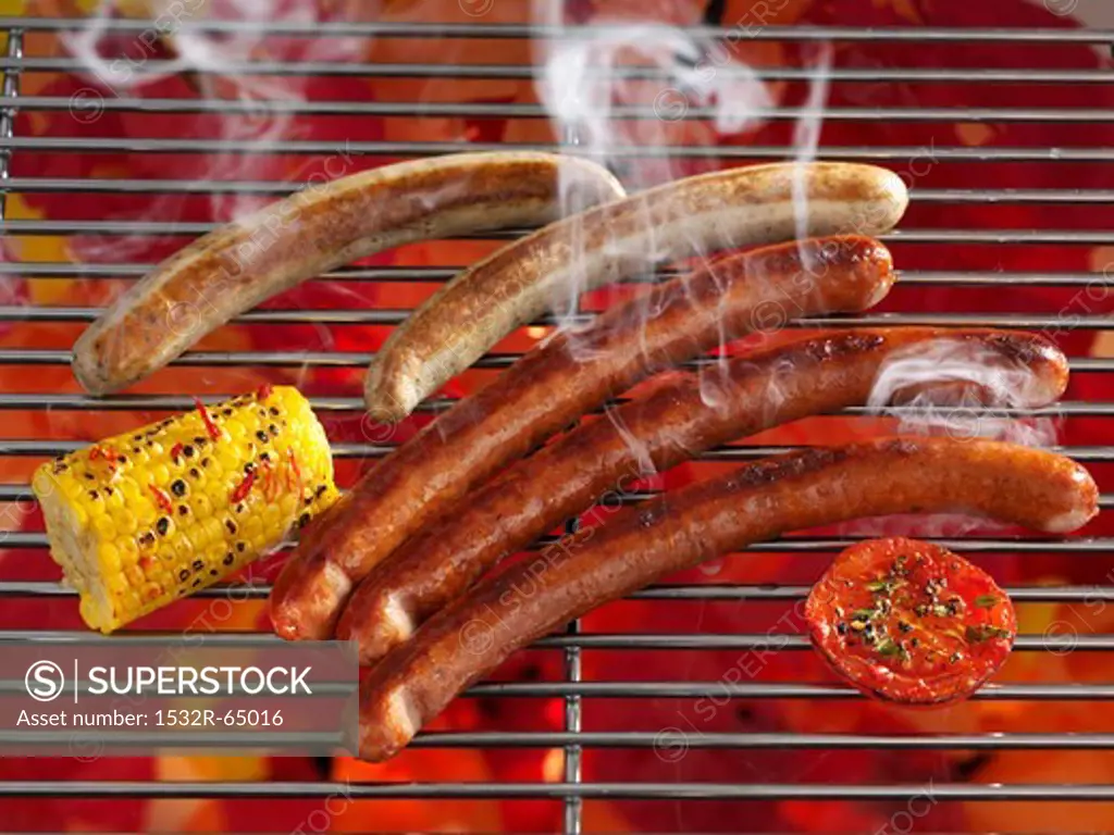 Smoking sausages on a grill
