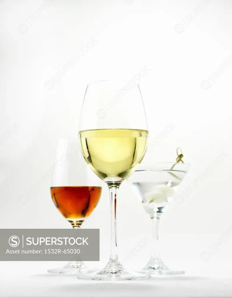 A glass of white wine, a martini and a glass of sherry