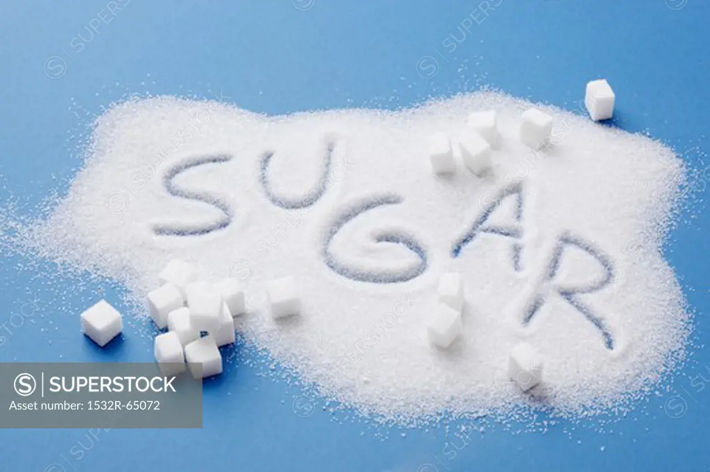 A pile of sugar with the word SUGAR written in it