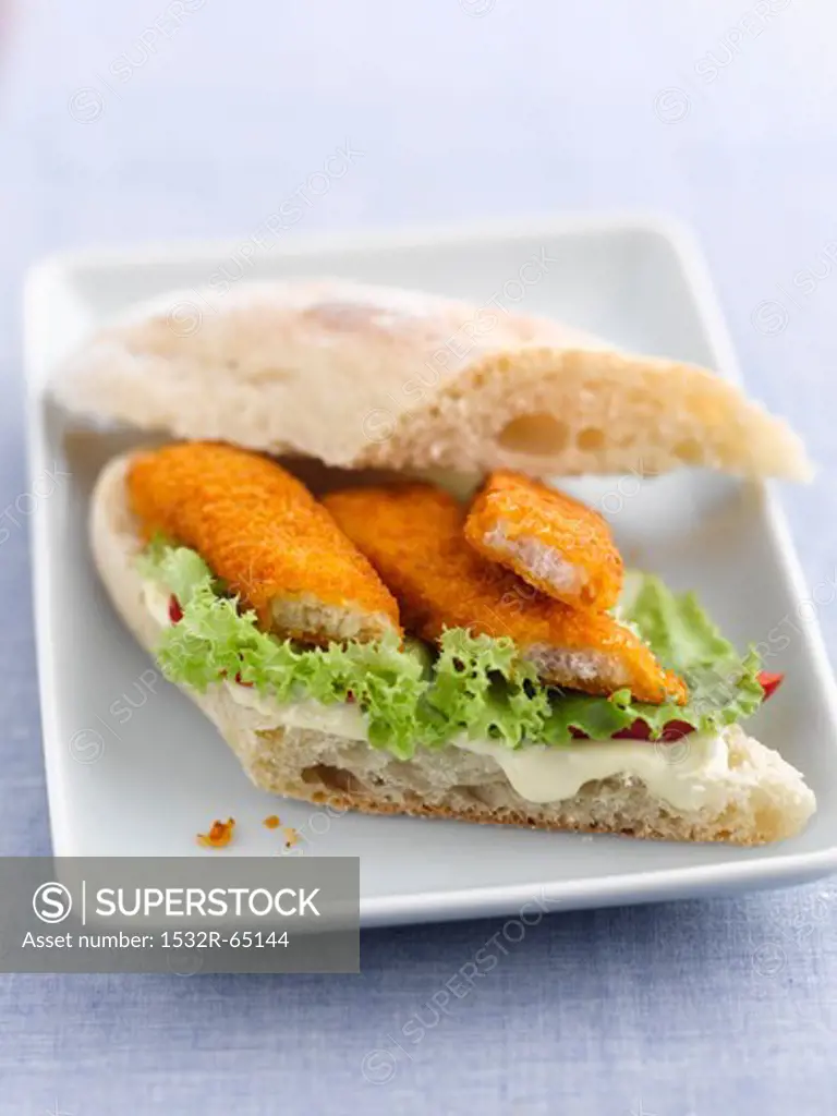 A fish finger sandwich with lettuce and mayonnaise