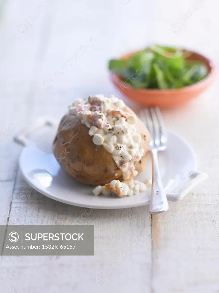 A baked potato with cottage cheese
