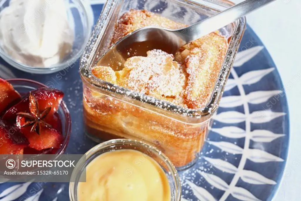 A cake in a jar with vanilla sauce, plum compote and cream