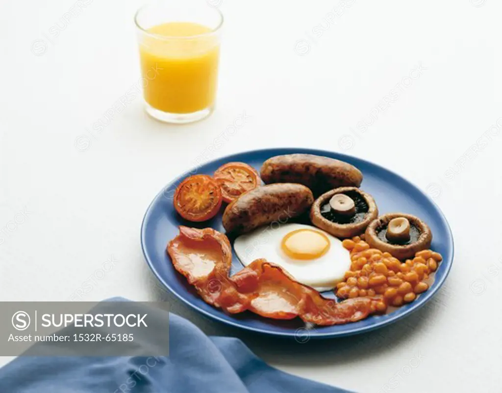 English breakfast with baked beans, fried egg, bacon and sausage