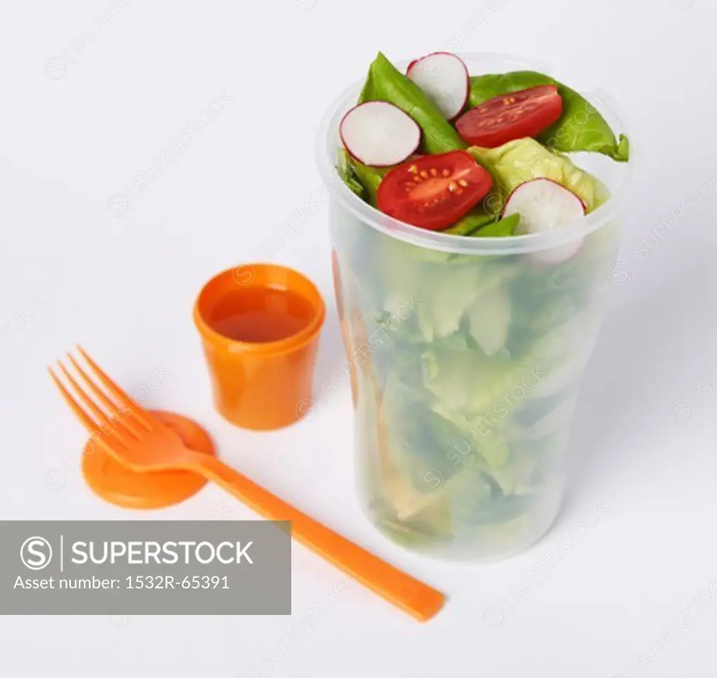 Salad in a To-Go Container with a Small Container of Dressing and a Plastic Fork