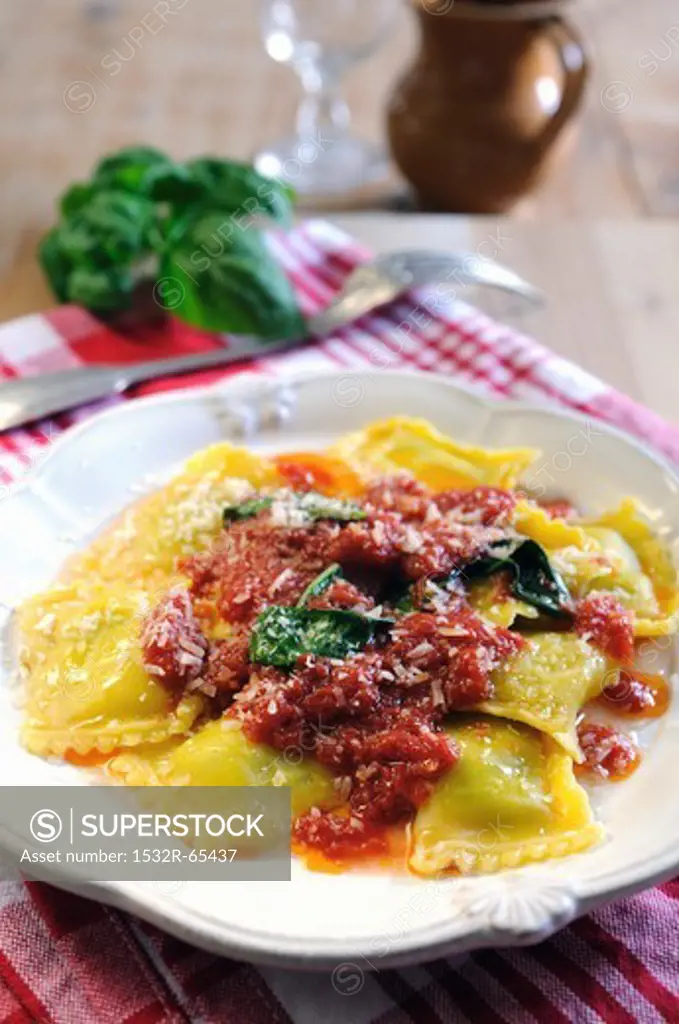 Spinach and ricotta filled ravioli pasta with tomato and fresh basil sauce