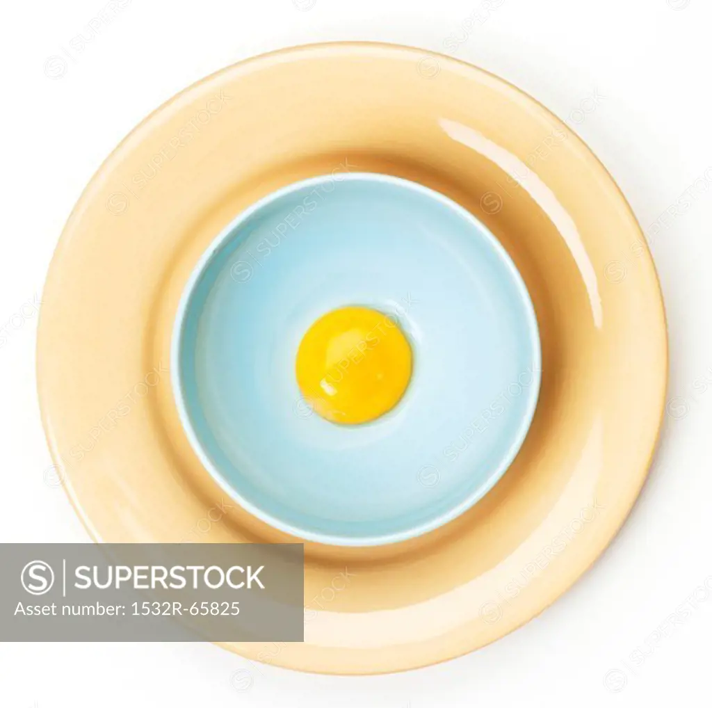 Egg Yolk in a Bowl on a Plate; From Above