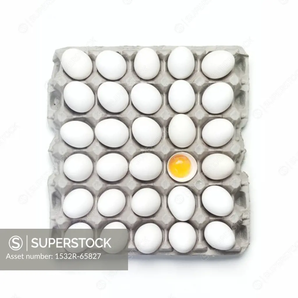 Many Whole White Eggs in a Carton; One Broken Open