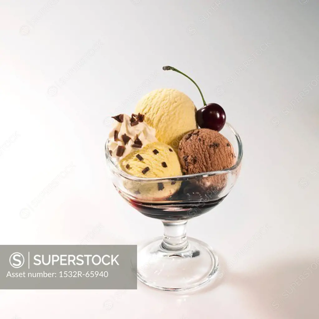 Chocolate and vanilla ice cream sundae with cherry sauce and cherries