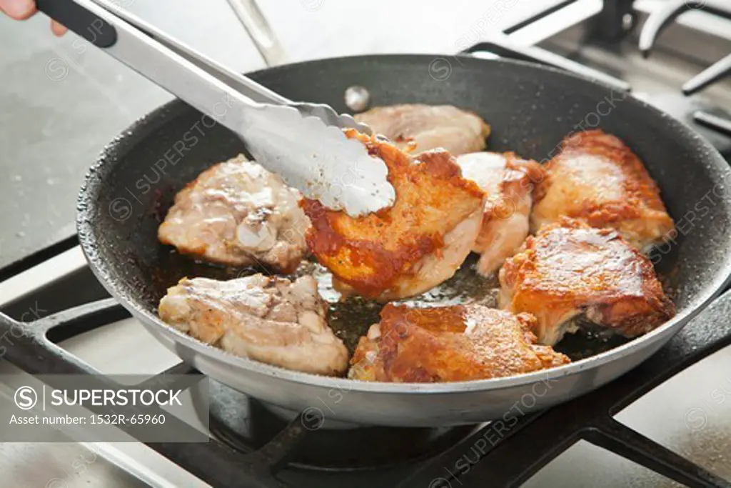 Browning Chicken in a Skillet; Flipping with Tongs