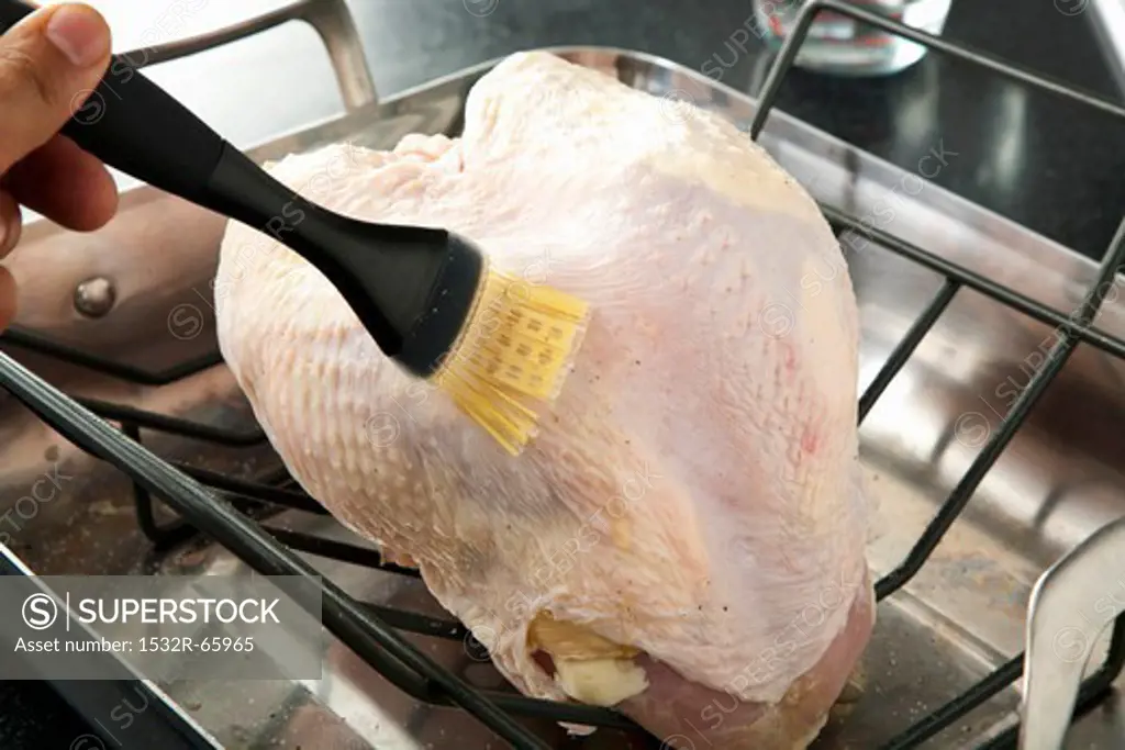 Brushing Butter on a Turkey Breast in the Oven for Roasting