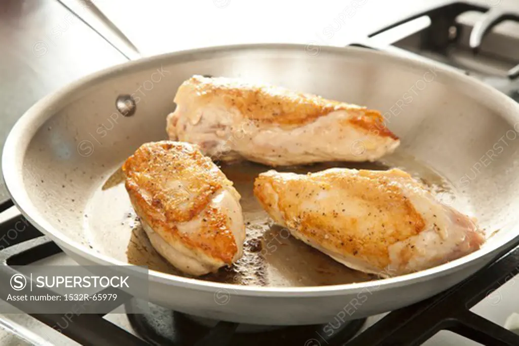 Browning Chicken Breasts in a Skillet on an Oven