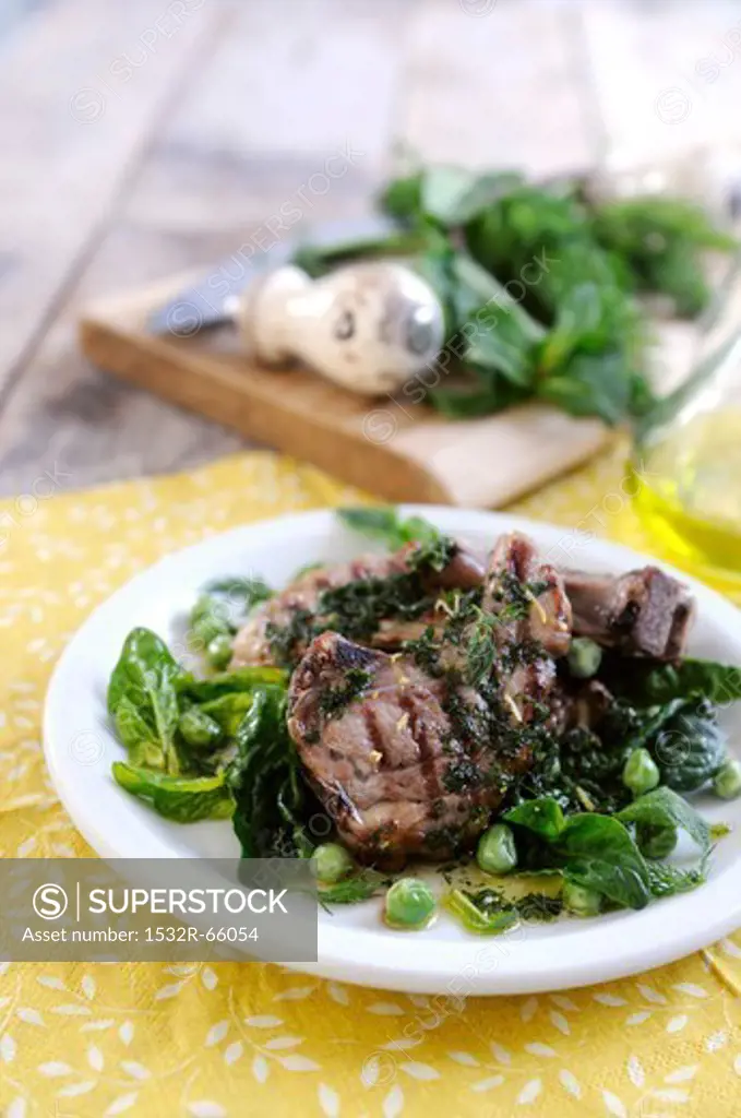 Lamb chops with a spinach and pea salad and parsley sauce