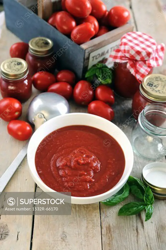 Freshly made tomato sauce in a bowl and in jars