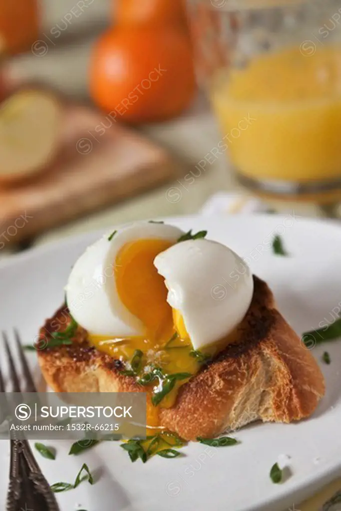 A Soft Boiled Egg Oozing Over Thick Cut Toasted Garlic Bread