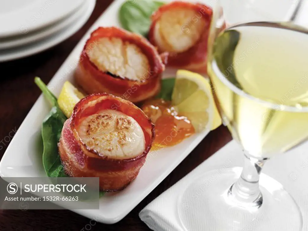 Bacon Wrapped Scallops on a Platter; Glass of White Wine